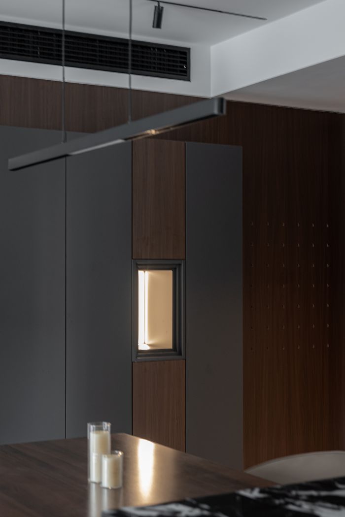 Modern interior with warm lighting, featuring wood and neutral tones.